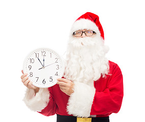 Image showing man in costume of santa claus with clock