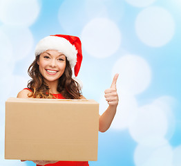 Image showing smiling woman in santa helper hat with parcel box