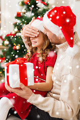 Image showing smiling father and daughter holding gift box