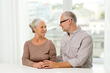 Image showing happy senior couple sitting on sofa at home