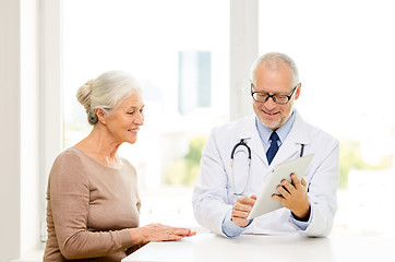 Image showing smiling senior woman and doctor with tablet pc