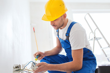 Image showing builder with tablet pc and equipment indoors