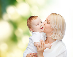 Image showing happy mother kissing smiling baby