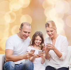 Image showing happy family with smartphones