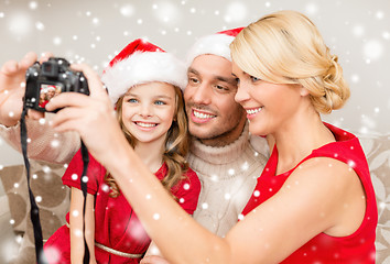 Image showing happy family with digital camera taking photo