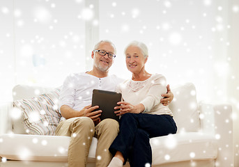 Image showing happy senior couple with tablet pc at home