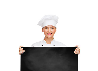 Image showing smiling female chef with white blank board