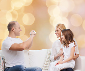 Image showing happy family with camera at home