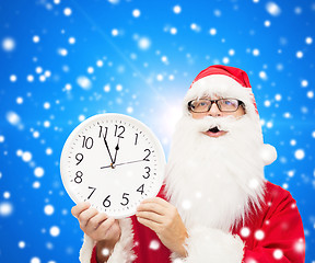 Image showing man in costume of santa claus with clock