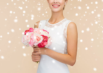 Image showing close up of woman in white dress with flowers