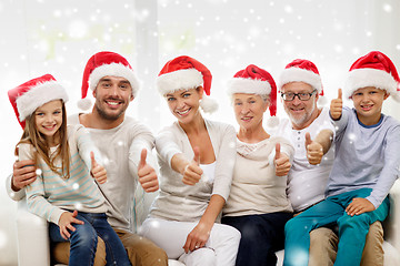 Image showing happy family sitting on couch at home