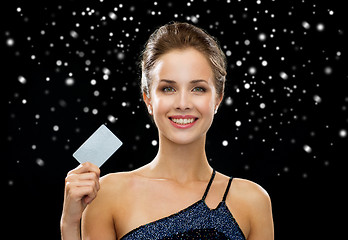 Image showing smiling woman in evening dress holding credit card