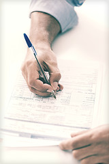 Image showing man signing a contract