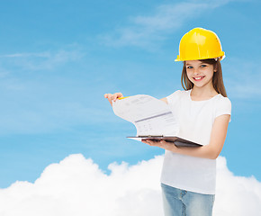 Image showing smiling little girl in hardhat with clipboard