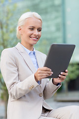 Image showing smiling businesswoman with tablet pc outdoors