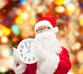 Image showing man in costume of santa claus with clock