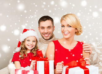 Image showing smiling family holding many gift boxes