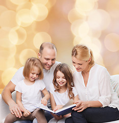 Image showing happy family with book at home