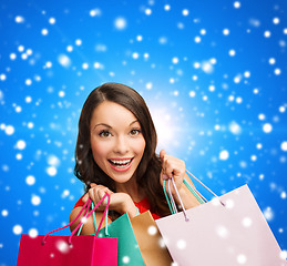 Image showing smiling woman with colorful shopping bags