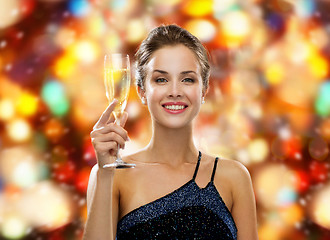 Image showing smiling woman holding glass of sparkling wine