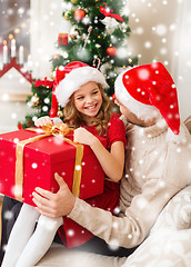 Image showing smiling father and daughter holding gift box