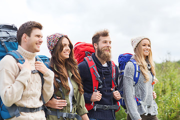 Image showing group of smiling friends with backpacks hiking