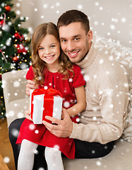 Image showing smiling father and daughter holding gift box