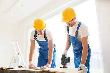 Image showing group of builders with tools indoors