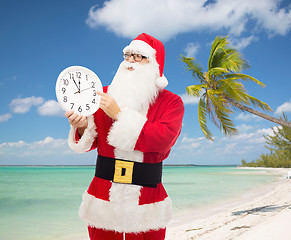 Image showing man in costume of santa claus with clock