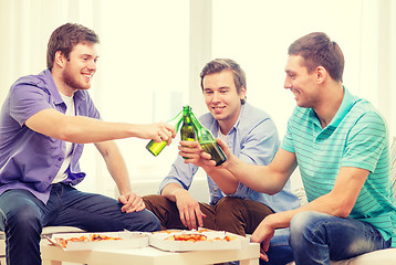 Image showing smiling friends with beer and pizza hanging out