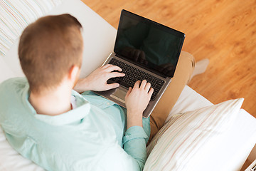 Image showing close up of man working with laptop at home