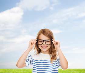 Image showing smiling cute little girl with black eyeglasses