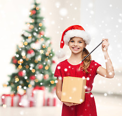 Image showing smiling girl in santa helper hat with gift box