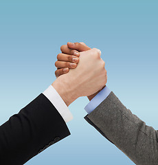 Image showing close up of two hands multiracial armwrestling