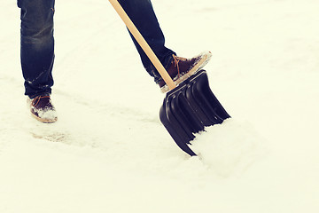 Image showing closeup of man shoveling snow from driveway