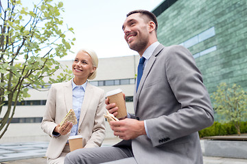 Image showing smiling businessmen with paper cups outdoors