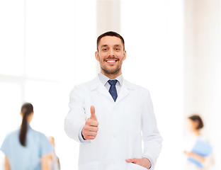 Image showing smiling male doctor showing thumbs up