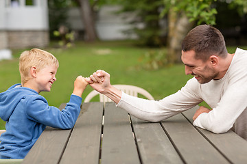 Image showing happy family in front of house outdoors