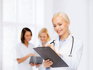 Image showing smiling female doctor with clipboard