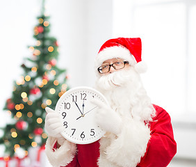 Image showing man in costume of santa claus with clock