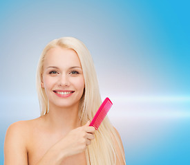 Image showing smiling woman with hair brush