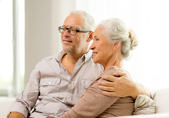 Image showing happy senior couple sitting on sofa at home