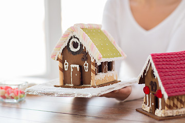 Image showing close up of woman showing gingerbread house