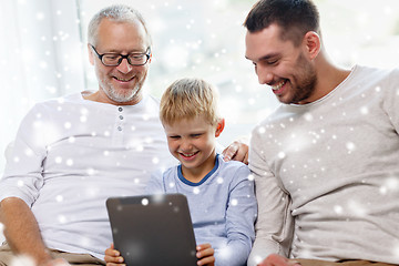 Image showing smiling family with tablet pc at home