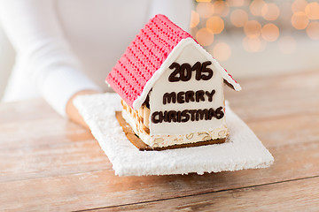 Image showing close up of woman showing gingerbread house