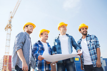 Image showing group of builders with tablet pc and blueprint