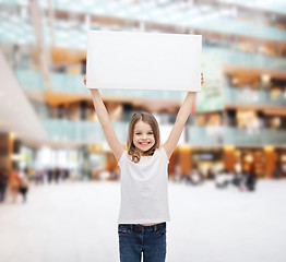 Image showing smiling little girl holding blank white board