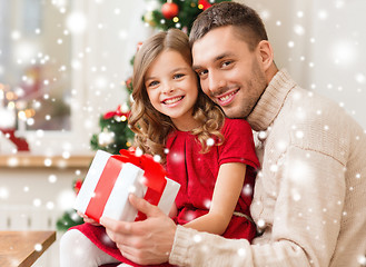 Image showing smiling father and daughter holding gift box