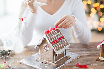 Image showing close up of woman making gingerbread houses