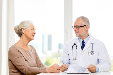 Image showing smiling senior woman and doctor meeting